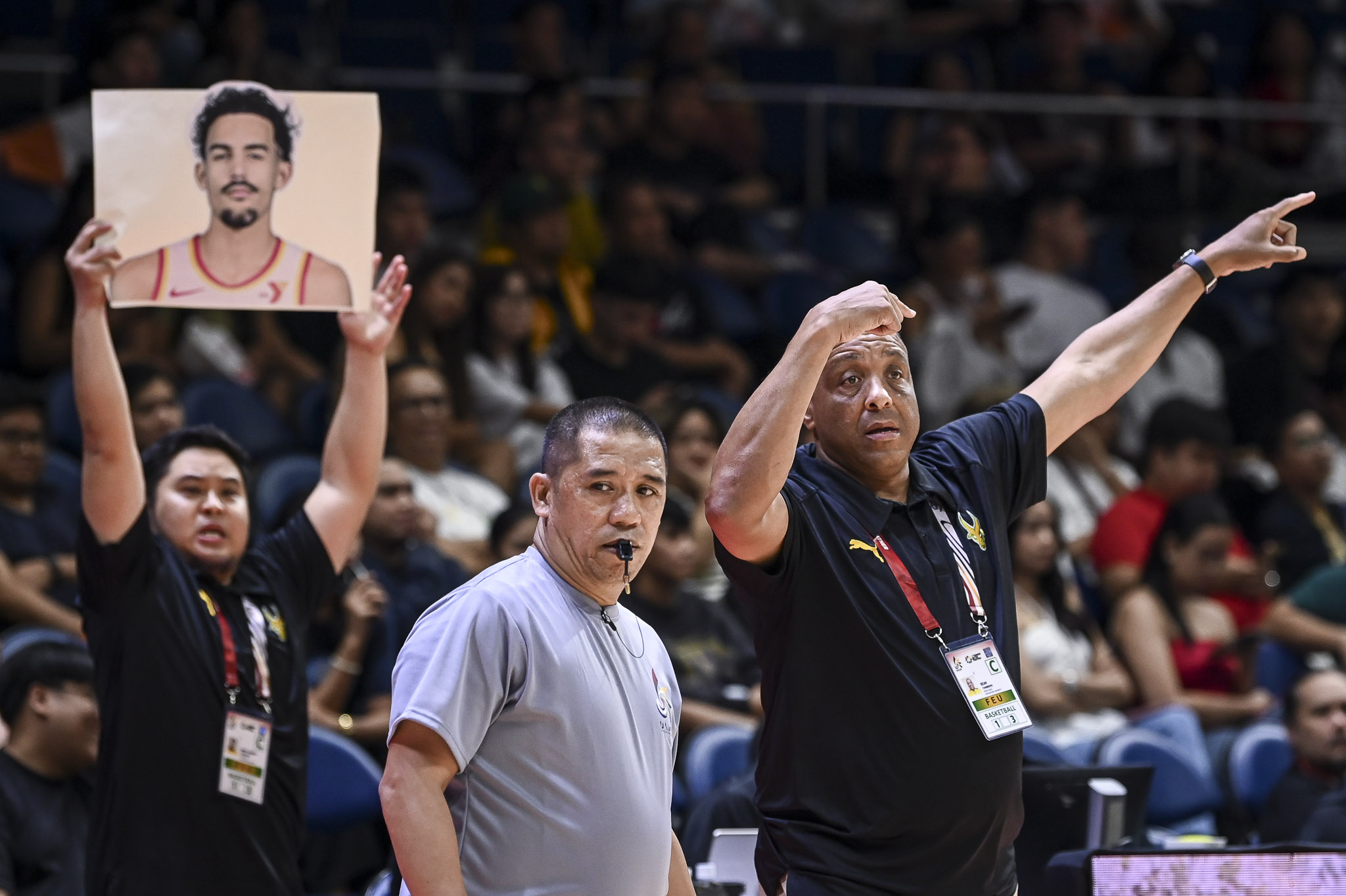 FEU head coach Sean Chambers with a 'Trae Young' placard in the background